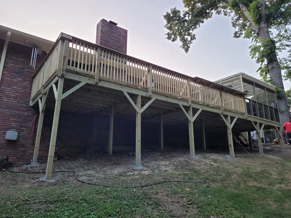 Residential wood deck project with railings and a screened outdoor area