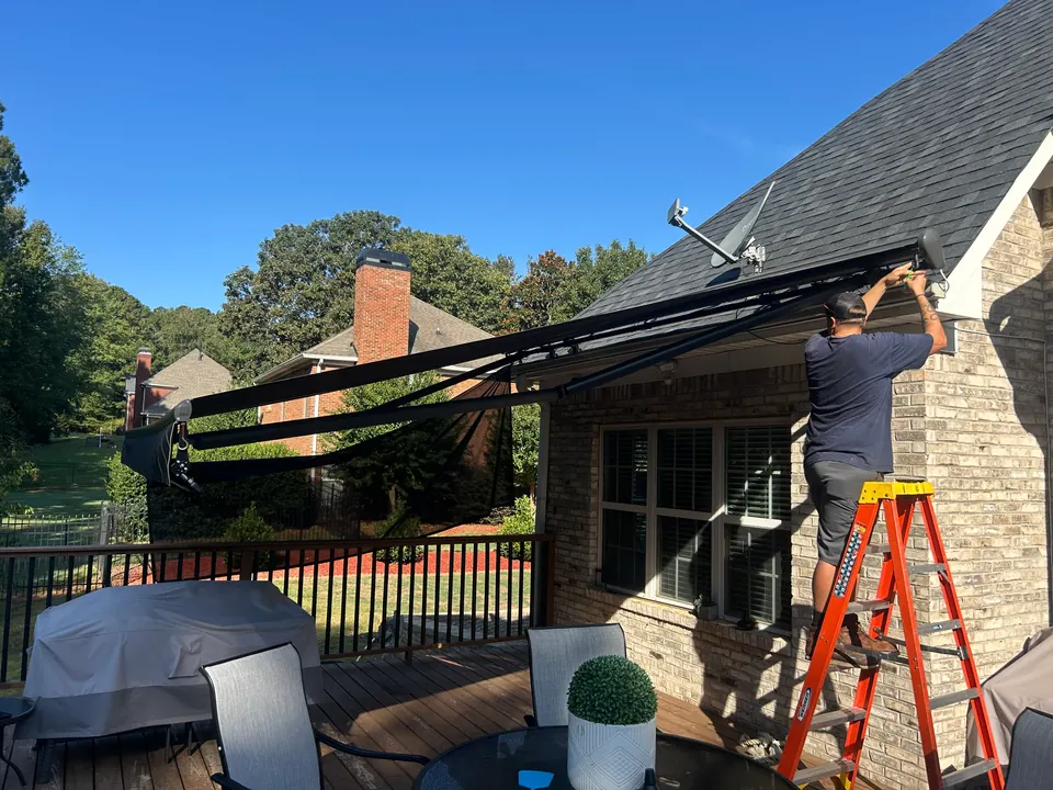 Technician adjusting a retractable awning