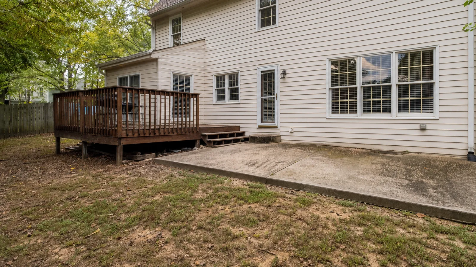 Before outdoor living upgrade with existing deck and unused backyard space